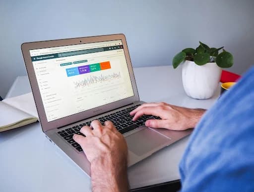 Man on a laptop looking at data analytics