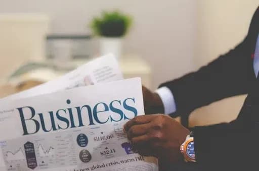 Person reading a news paper exploring 2025 business trends